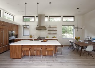 Dwell Home Tours Lands in Silicon Valley - Photo 15 of 15 - The combined kitchen/dining room is finished with walnut cabinets. The clerestory windows continue the same format as the rest of the house.