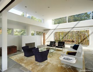 Marcel Breuer’s Revived Home Could be Yours for Just Under $5 Million - Photo 4 of 8 - The ceiling heights were preserved throughout much of the house while skylights were placed all around the perimeter of the main structure. The living room holds an original fireplace (shown here).