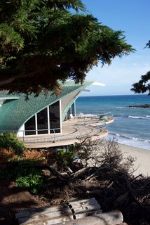 The Wave House sits directly next to the Sandcastle on the sands of Malibu. When Gesner created it in 1957, the design had originally been born when he drew the shape of the house on his surfboard with a piece of grease pencil while he was waiting for the perfect wave. When he got back to land, he transferred it to a drawing pad and vellum before turning it into a reality. He found inspiration in the way a giant wave embraces you—and how you become a part of it. The roof is lined with copper shingles that are layered in a way that gives the impression of fish scales. 
