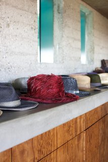 As an aficionado of fashion—along with architecture and basketball—Goldstein visits all of the biggest fashion shows and design houses around the world. He installed an automatic rotating closet that houses his illustrious men's fashion collection. He also proudly showcases his favorite pieces along the concrete shelving in the bedroom.