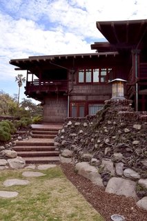 Inspired by Japanese architecture, the Greenes ensured that there were no hard edges to be found on the property. Everything is round and smoothed out, including the bricks in the yard. The exterior of the house is lined with Douglas fir and the extended overhanging eaves act as cooling agents while protecting the porch from the rain. 
