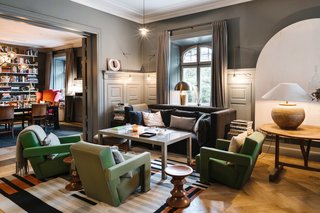 The communal living room acts a social space where guests can mingle and relax. Cozy furniture and warm lighting makes the space feel more like a home than a hotel.