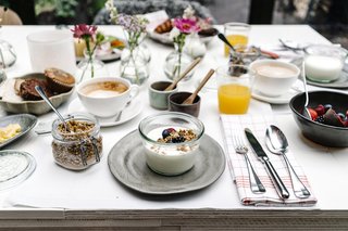 A complimentary breakfast is served each day, which includes fresh yogurt, house-made granola, pastries, avocado toast, and cheese.