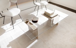 Jung and Hurewitz designed the custom angular glass and oiled oak coffee table, and set it next to a pair of vintage chairs. The round hand-turned walnut mirrors on the table were also custom produced and provide a space to showcase Lee’s jewelry. 