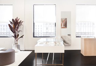 Lee’s jewelry is contained in bespoke polished brass and white oak displays. The interior is lined with traditional linen jewelry holders.