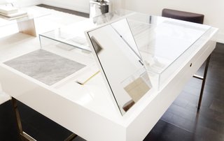 This particular display includes marble trays and mirrors that flip up while concealing ring sizers and additional inventory.