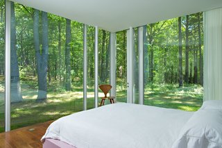 The master bedroom in the guest house is clean and simple, shown here with a Cherner Side Chair posted up in the corner.