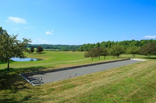Along with a tennis court, the property also features a bocce court, which sits adjacent to the outdoor pool.