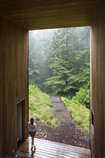 A small courtyard cut out of the center holds a sheltered terrace with an outdoor fireplace. This open area separates the main living spaces from the bedrooms and creates a framed view for the family.<span> <a href="/discover/dwelllpow">#dwelllpow</a></span>