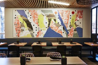 A Popular Burger Joint Flaunts Its Roots With the Help of a Design Collective - Photo 4 of 8 - The graphics team at Project M Plus created street-inspired décollage wall art for both locations. Made popular by artists François Dufrene, Jacques Villeglé, and Raymond Hains, this technique is created by layering posters on top of each other, and then tearing away pieces to reveal what’s below. This wall art (at the Santa Monica location) is inspired by Japanese graphics and slang—and also incorporates vintage postcards.