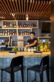 A Popular Burger Joint Flaunts Its Roots With the Help of a Design Collective - Photo 5 of 8 - The bar at the Santa Monica stop features crackled ceramic tile from Heath Ceramics. It’s shown here in a layered, glazed finish in chalk and gunmetal.