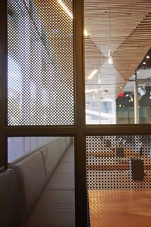 A Popular Burger Joint Flaunts Its Roots With the Help of a Design Collective - Photo 7 of 8 - In order to help create a bit of privacy in certain areas of the Santa Monica locale, they created perforated metal screens that were are by traditional shoji screens.