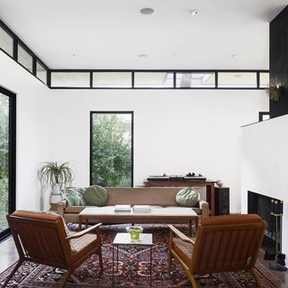 This photo that Calo took of the central living space is marked by tall ceilings, clerestory windows, and a cold-rolled steel fireplace. 