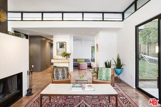 The open layout is connected to private gardens with floor-to-ceiling glass. 