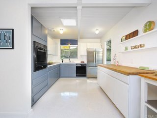 The kitchen is spacious and includes plenty of counter space to cook and entertain. Throughout the house, original radiant floor heating is still operable to this day. The surface has been updated with newer VCT flooring.