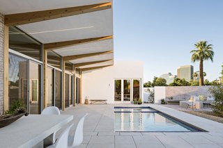 A Desert Oasis Awaits in a Historic District of Phoenix - Photo 1 of 2 - The U-shape courtyard-style house has a cantilevered roof that forms a sheltered outdoor living area—which allows breezes to flow directly into the living room when the doors are open. 