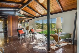 The interior features glossy finished concrete floors and a number of original globe lights overhead. 