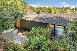 Nate Cole of Coldwell Banker explained that this home is possibly the only one of its kind in the neighborhood. The front of the house sits slightly hidden from the street and boasts a vibrant orange front door. 
