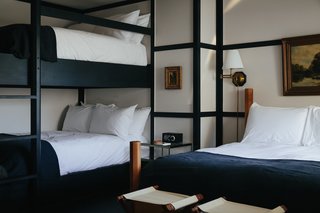 The beds are topped off with custom hand-dyed French linen blankets from Brooklyn-based Sharktooth. Additionally, each room is finished with high-gloss painted plywood floors that have a decorative wood trim running the edge of the room. 