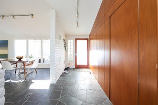 Similar to other Fickett homes—which the neighborhood is filled with—it includes original paneling throughout the home and brickwork that’s been painted white. 