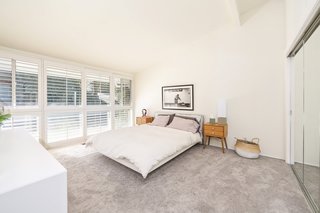 A past renovation included installing carpets into the bedrooms, which have been left clean and simple.