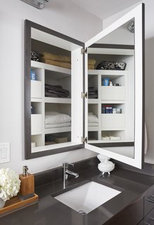 Though they made these changes to the vanity area, they preserved the depth behind the medicine cabinets for linen storage. 
