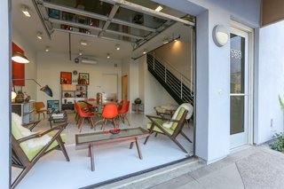 When you first approach the loft, you can choose to enter through a simple door, or through the garage door that slides back completely. This reveals the main workshop floor that has its own bathroom and painted concrete floors. 