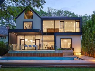 15 Modern Additions to Traditional Homes - Photo 6 of 15 - While Audax reconstructing the front facade with restored brick, wood trim, and new stucco, they built a new modern addition onto the back. They also rebuilt the roof to reflect the original design, which ensures that the house still feels like one residence.