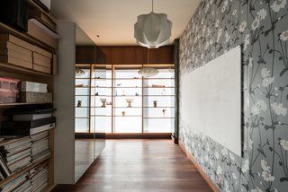 Formerly Home to an Artist and Knitwear Designer, a Commercial Space-Turned-Dwelling Hits the Market - Photo 8 of 10 - The home includes a basement that has a laundry room and a miscellaneous space that the recent owners have turned into a workshop and store room. This gallery-like room displays collections of cherished objects along with a mix of hanging pendant lamps by George Nelson. 