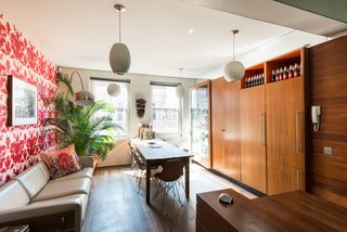 Formerly Home to an Artist and Knitwear Designer, a Commercial Space-Turned-Dwelling Hits the Market - Photo 3 of 10 - The dining space and kitchen are connected in a long, narrow space that's lined with floor-to-ceiling cabinets. 