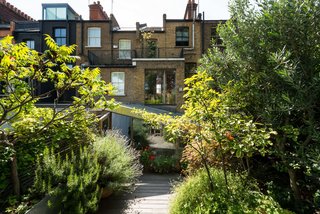 Formerly Home to an Artist and Knitwear Designer, a Commercial Space-Turned-Dwelling Hits the Market - Photo 10 of 10 - From the front entrance, you would never be able to tell what exists behind the glazed doors—let alone the fact that there’s a verdant garden in the back that offers privacy and a dose of nature. 