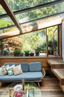 Formerly Home to an Artist and Knitwear Designer, a Commercial Space-Turned-Dwelling Hits the Market - Photo 5 of 10 - One of the additions that took place during Brinkworth’s second phase of extensions is the glazed garden room, which sits half a level below the first floor. Handcrafted wooden steps lead to a terraced garden outside.