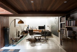 Formerly Home to an Artist and Knitwear Designer, a Commercial Space-Turned-Dwelling Hits the Market - Photo 2 of 10 - Once you enter, a hallway leads you into a reception/living area with polished-concrete floors and paneled walls that are partly lined with iroko wood. A double-height section lets in slices of light from the galleried garden room above.