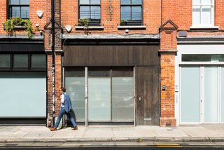 Formerly Home to an Artist and Knitwear Designer, a Commercial Space-Turned-Dwelling Hits the Market - Photo 1 of 10 - Located on one of Spitalfield’s most coveted streets, the Fashion Street Residence sits hidden behind a partially glazed facade that’s reminiscent of its commercial building history.