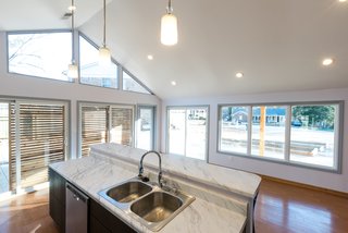 One of the other main plans the architecture team proposed was to build a glass addition on one end of the house that would introduce natural light into the kitchen and dining area. 