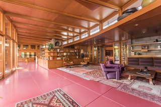 The red flooring that runs throughout the interior is Colorundum in Cherokee red, a color Wright loved to use in his projects. Jim Gricar of Houlihan Lawrence explains that the flooring is made up of a series of minerals that have a low freezing point, which makes it difficult to crack. 