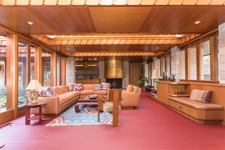 In the family room—which also holds a gold leaf-covered concrete fireplace—large skylights run the width of the space. 