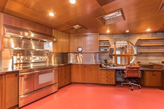 Though the appliances have been updated, the rest of the kitchen is original, including the cabinets, piano hinges, and the painted glass windows on the ceiling. 