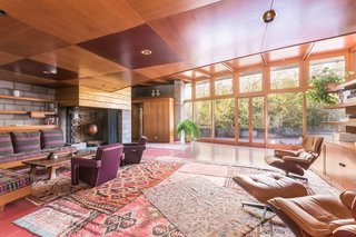 The original living room holds a number of furniture pieces that Wright designed. Since he enjoyed interweaving textures and materials, he created a fireplace that’s made of concrete block—but painted with gold leaf. Gricar explains, "He loved the material play between fancy and utilitarian." 