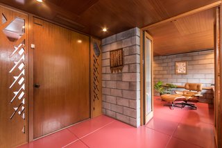 The interior of the home is almost completely lined with mahogany, along with sections of concrete blocks. Wright’s design called for different cuts of wood to be placed together, which creates a rich layered effect. 