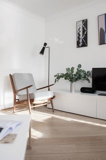 Shown here is a midcentury Scandinavian lounge chair that Silvia just discovered at a vintage market in London. It’s supported with elm wood and has been newly upholstered with a 100-percent Wool Camira fabric. It sits next to an Ikea TV stand and a set of three photographs that Silvia and her boyfriend made themselves. They chose photographs they took of three places they love—Barcelona, London, and Ireland—and printed them onto metal.