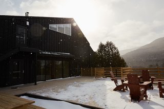 A Modern Mountain Lodge That Will Make You Love Winter Like Never Before - Photo 12 of 13 - A communal fire pit on the wrapped patio offers a space to relax outdoors while being fully immersed in the mountains.