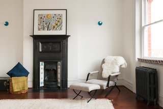 This bedroom shows another example of how they preserved certain characteristic elements, including an original fireplace and radiators. 