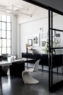 Hollis shares this office with her husband and CEO, Lewis Heathcote. Panton Chairs, designed by Verner Panton for Vitra, can be found in various areas of the office. Poured concrete floors are kept consistent throughout the space.