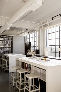 Hollis made sure to create areas where vendors, artists, and artisans can drop off their work or samples. Shown here is the materials library and high-top tables that provide storage and allow for casual, impromptu meetings.