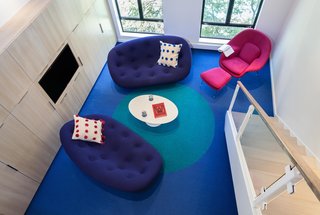 Bright Colors and Sleek White Oak Fill This Playful Lake Tahoe Loft - Photo 8 of 9 - As a rug designer, Simon planned out the large blue dot on the bright blue Tretford carpet. Simon explains that this tough flooring material is made with ribbed goats hair and has recently made a comeback after being a popular wall covering material in the 1970s.