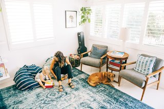 Indoek’s New Book Shares a Glimpse Into the Homes of Creative Surfers - Photo 11 of 11 - Grant Ellis’s wife Julie and daughter Kaia are shown here in their cozy, indigo-filled living room in Cardiff, California. 