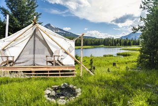 Get the Modern Camping Experience You Crave at One of These New Secluded Retreats - Photo 2 of 11 - The team behind Collective Retreats built the custom canvas tents with wood that they sourced locally. They used timber they found in the property’s vicinity to hold the peaks together at the top. Shown here is the Yellowstone location. 