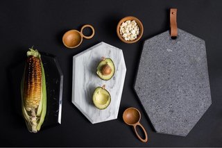 AYRES creates geometric cheese boards made with various tones of marble, lava stone, and leather. 