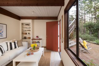 Shown here is the addition that was built by Jay's father to fit the rest of their large family. He made sure to keep the design, look, and materials as consistent with Liebermann’s main design as possible. They ended up painting the walls white in order to bring more light into the space.
